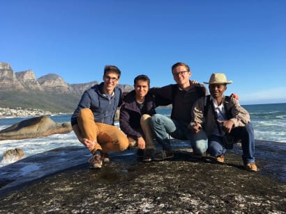 A group of students posing on a rock on the coasts of South Africa.